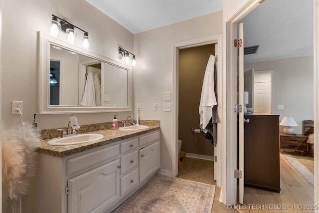 bathroom featuring vanity, hardwood / wood-style floors, and toilet