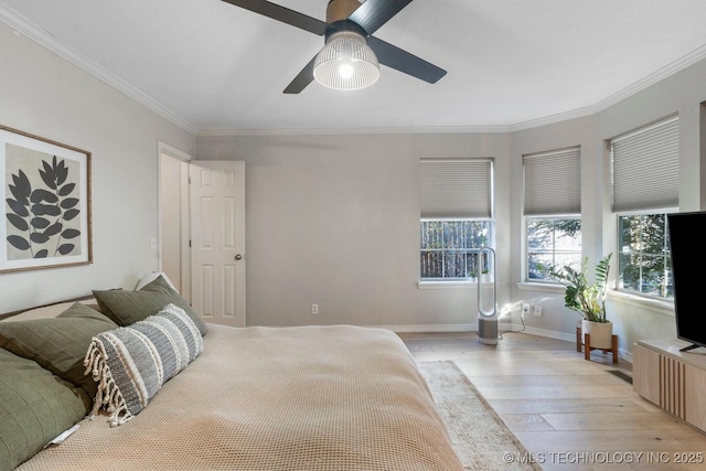 bedroom featuring ornamental molding, ceiling fan, and light wood-type flooring