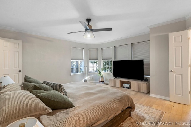 bedroom featuring ceiling fan, ornamental molding, and light hardwood / wood-style flooring