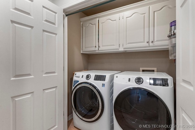 laundry area with cabinets and independent washer and dryer