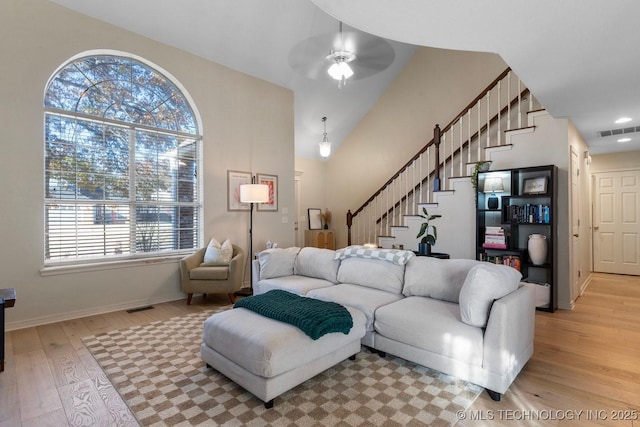 living room featuring light hardwood / wood-style floors and ceiling fan