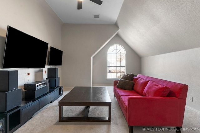 living room featuring vaulted ceiling, carpet floors, and ceiling fan