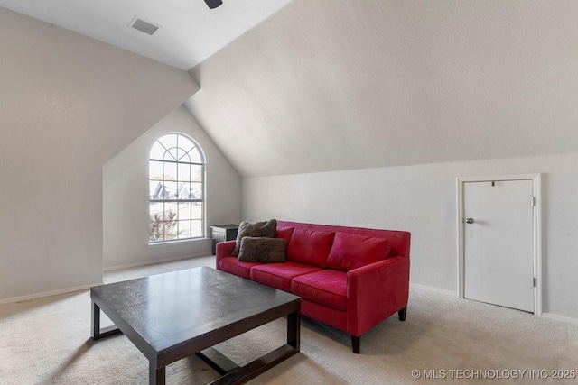 living room with lofted ceiling and light colored carpet