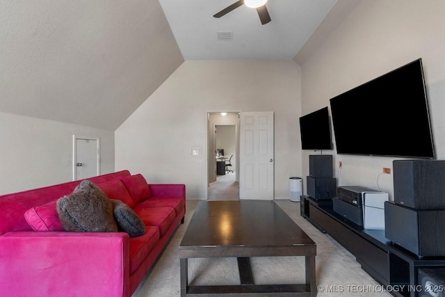 living room featuring ceiling fan, vaulted ceiling, and carpet