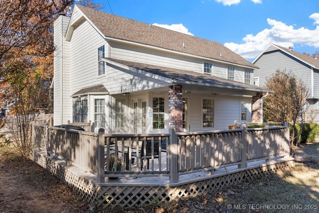 rear view of house featuring a wooden deck