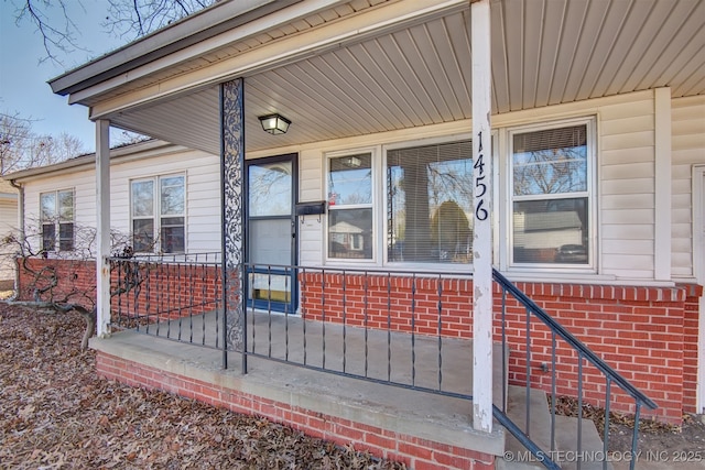 view of exterior entry with a porch