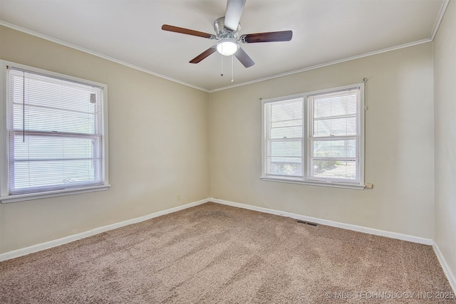 carpeted empty room with crown molding, a wealth of natural light, and ceiling fan