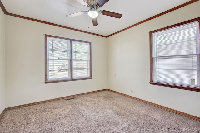 empty room featuring ceiling fan, ornamental molding, and carpet