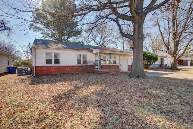 ranch-style home featuring a garage and covered porch