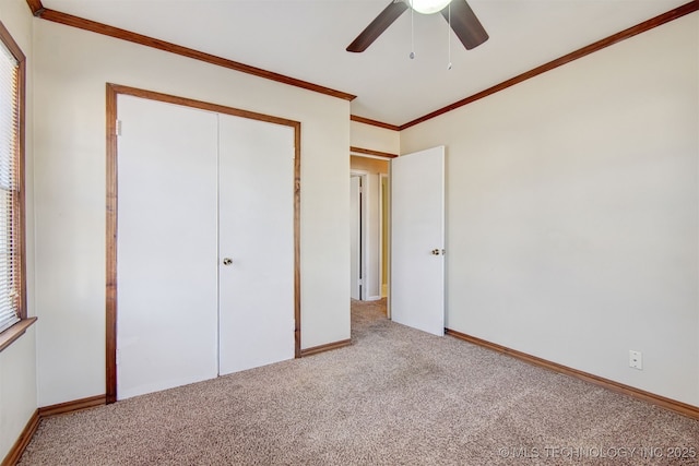 unfurnished bedroom featuring ornamental molding, light colored carpet, ceiling fan, and a closet