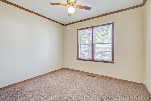 carpeted empty room featuring crown molding and ceiling fan