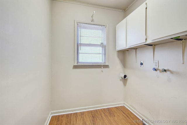 laundry area with cabinets, washer hookup, hookup for an electric dryer, and light hardwood / wood-style flooring