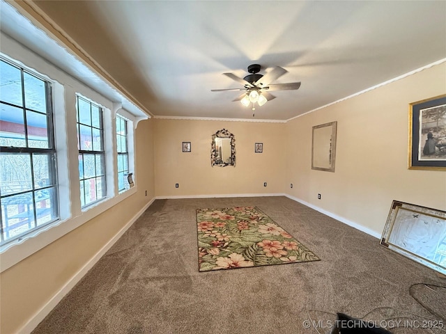 empty room with ornamental molding, ceiling fan, and carpet flooring