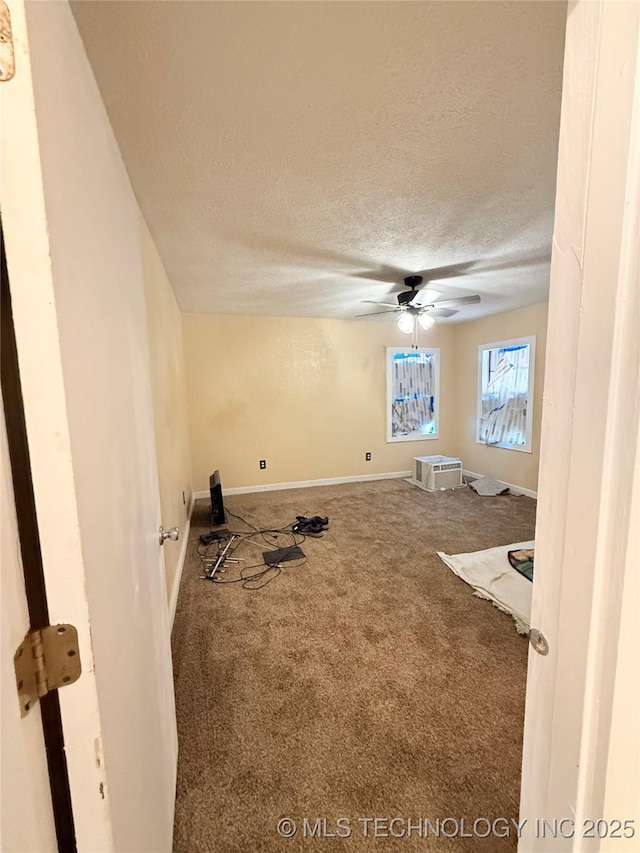 interior space featuring ceiling fan and a textured ceiling