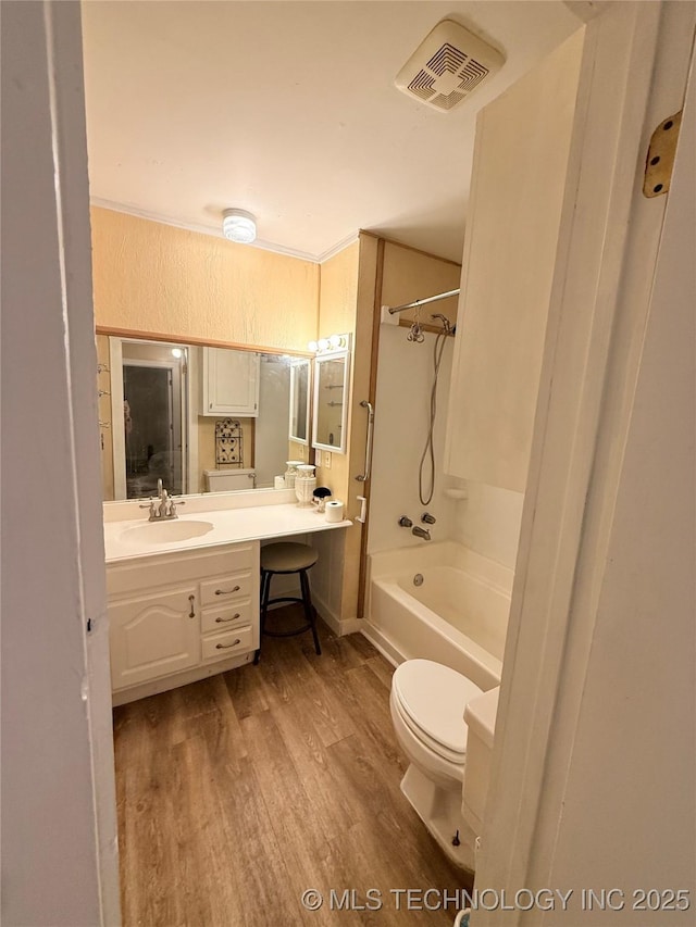 full bathroom with wood-type flooring, bathtub / shower combination, vanity, and toilet