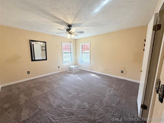 carpeted empty room featuring baseboards, ceiling fan, and a textured ceiling