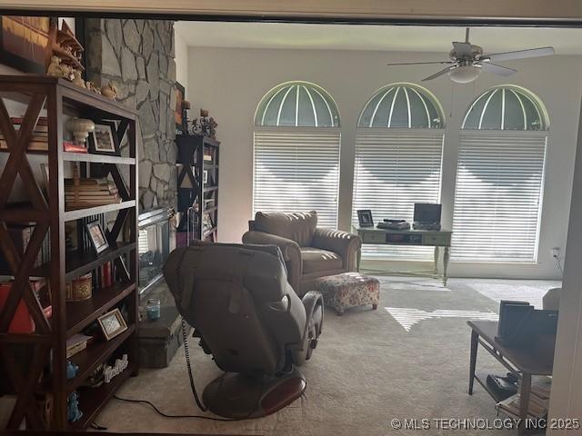 living room featuring ceiling fan and light carpet