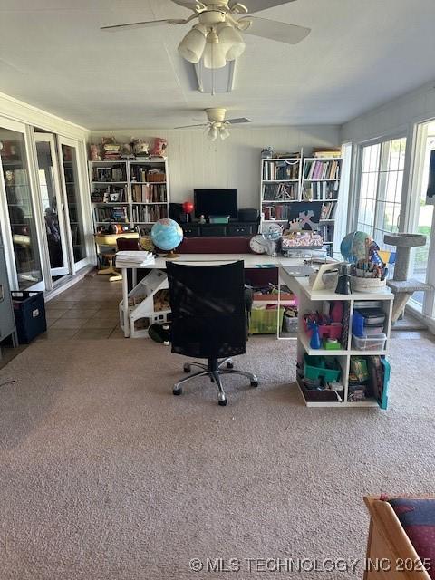 carpeted office featuring ceiling fan