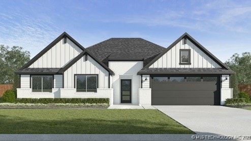 view of front of property with a garage and a front lawn