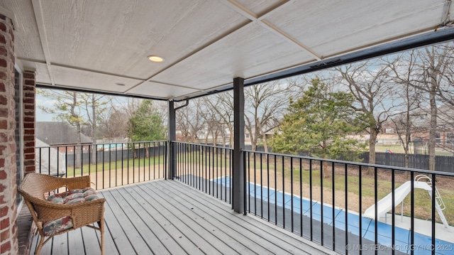 wooden terrace featuring a lawn