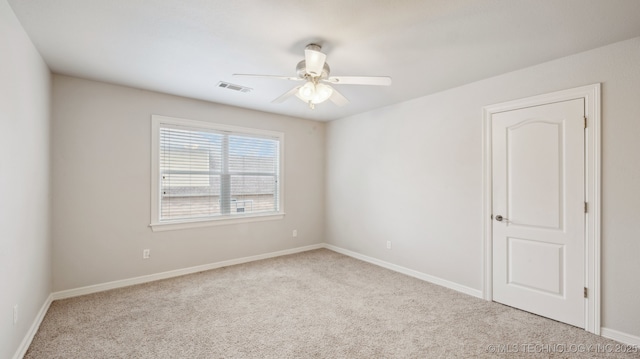 spare room with light carpet and ceiling fan