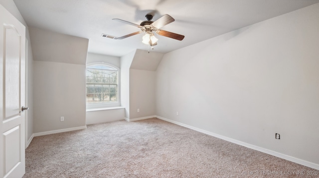 unfurnished room with light carpet, vaulted ceiling, and ceiling fan