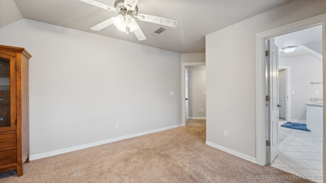 carpeted empty room with lofted ceiling and ceiling fan