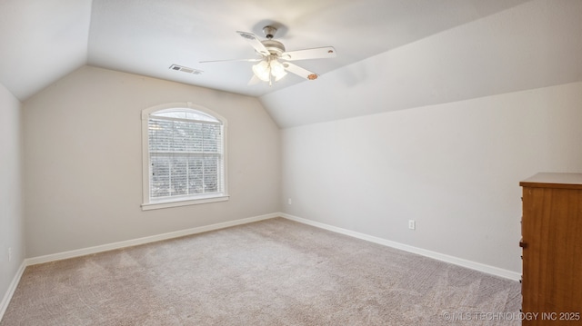 additional living space with light carpet, vaulted ceiling, and ceiling fan