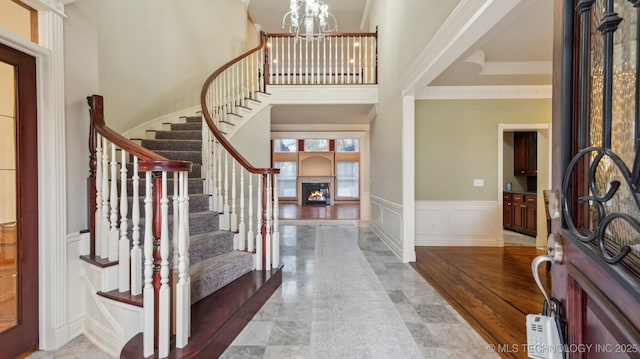 foyer with an inviting chandelier and a towering ceiling