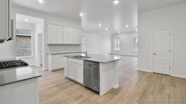 kitchen featuring dishwasher, an island with sink, sink, white cabinets, and light hardwood / wood-style flooring