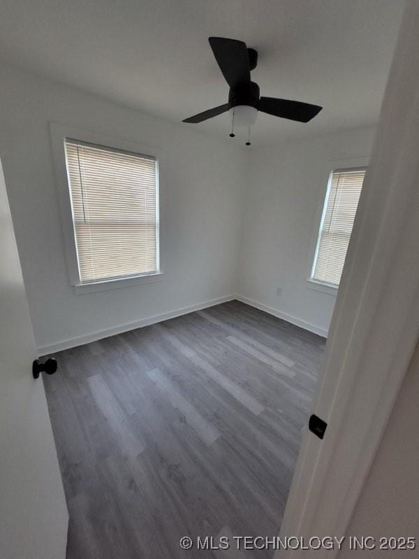 unfurnished room featuring dark hardwood / wood-style floors and ceiling fan