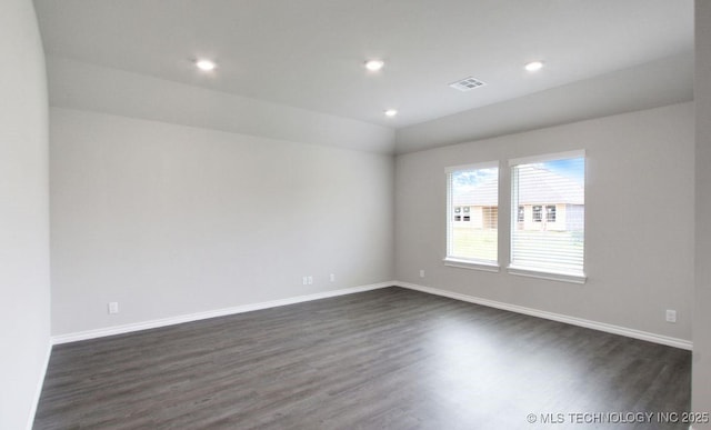 unfurnished room with dark wood-type flooring