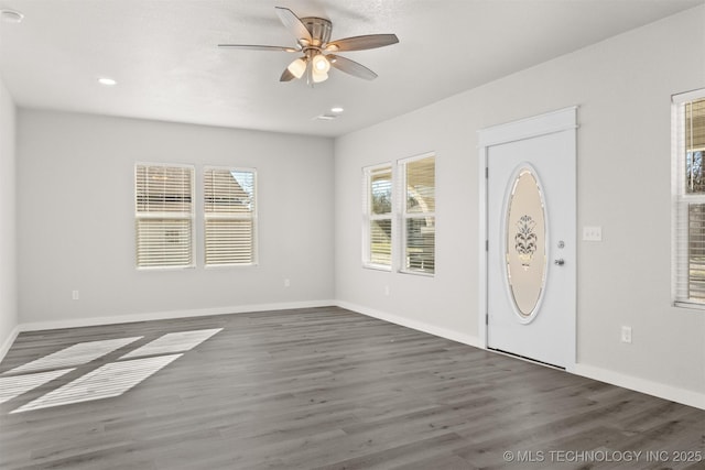 entryway with dark hardwood / wood-style flooring and ceiling fan