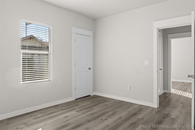 unfurnished bedroom with wood-type flooring