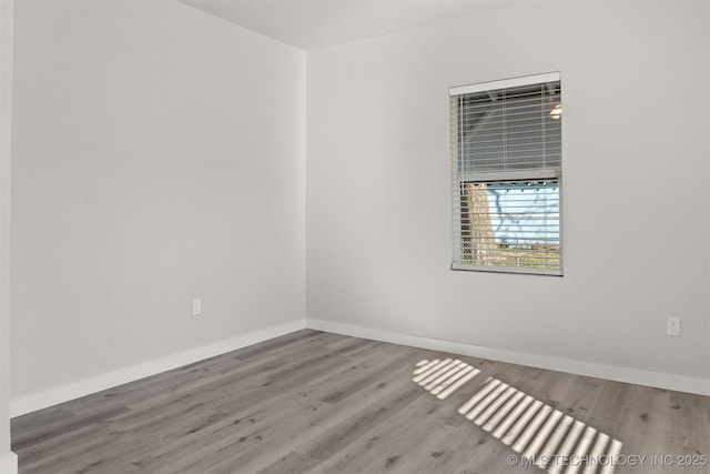 empty room with hardwood / wood-style flooring