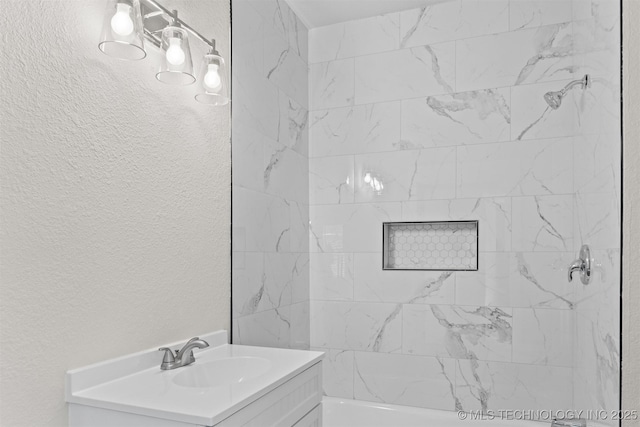 bathroom with vanity and tiled shower / bath combo