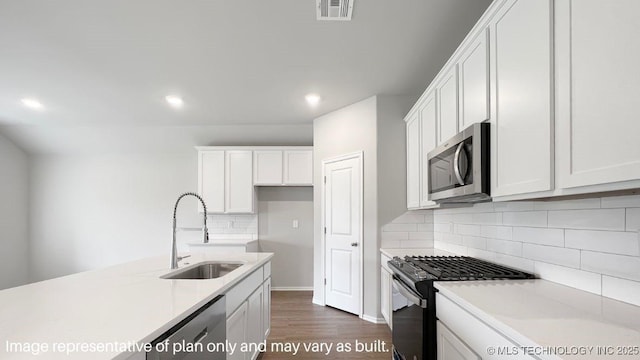 kitchen featuring white cabinetry, sink, and appliances with stainless steel finishes