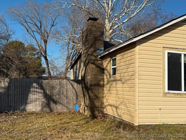 view of property exterior with a lawn