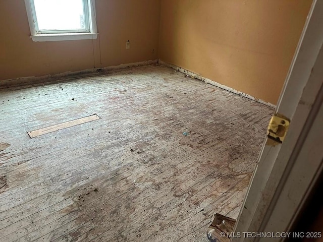 spare room with hardwood / wood-style flooring