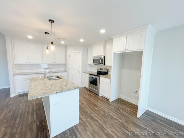 kitchen featuring sink, white cabinetry, a center island with sink, appliances with stainless steel finishes, and light stone countertops