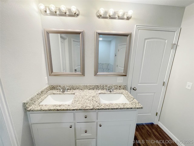 bathroom with hardwood / wood-style flooring and vanity