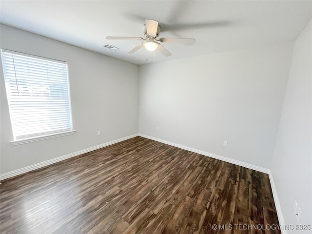 empty room featuring ceiling fan and dark hardwood / wood-style floors