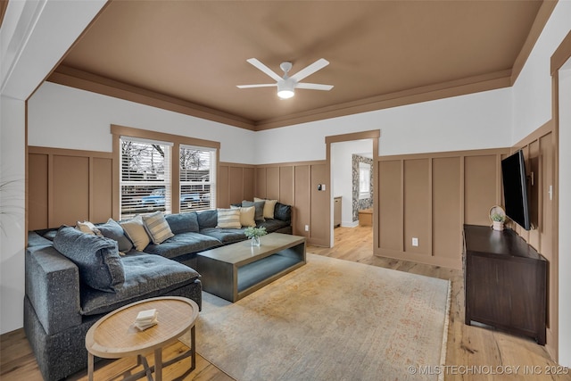 304 E Dallas St, Broken Arrow, OK 74012 - living area featuring a decorative wall, ceiling fan, a wainscoted wall, and light wood finished floors