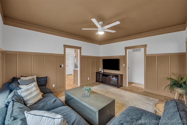 304 E Dallas St, Broken Arrow, OK 74012 - living area with a decorative wall, ceiling fan, light wood-style flooring, and a wainscoted wall