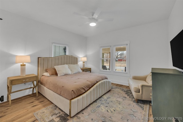 bedroom with ceiling fan and light hardwood / wood-style floors