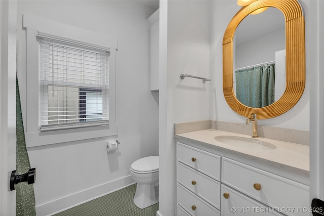 bathroom featuring vanity, tile patterned floors, and toilet