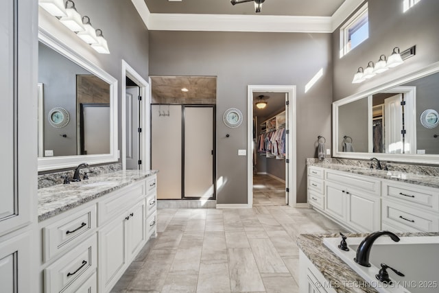 bathroom with ornamental molding, separate shower and tub, and vanity