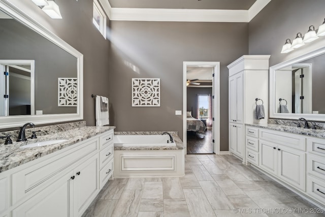 bathroom featuring vanity, crown molding, a tub, and ceiling fan