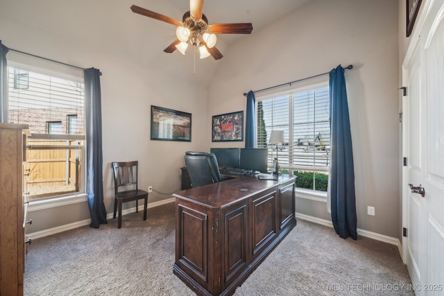 office space featuring lofted ceiling, light carpet, and ceiling fan