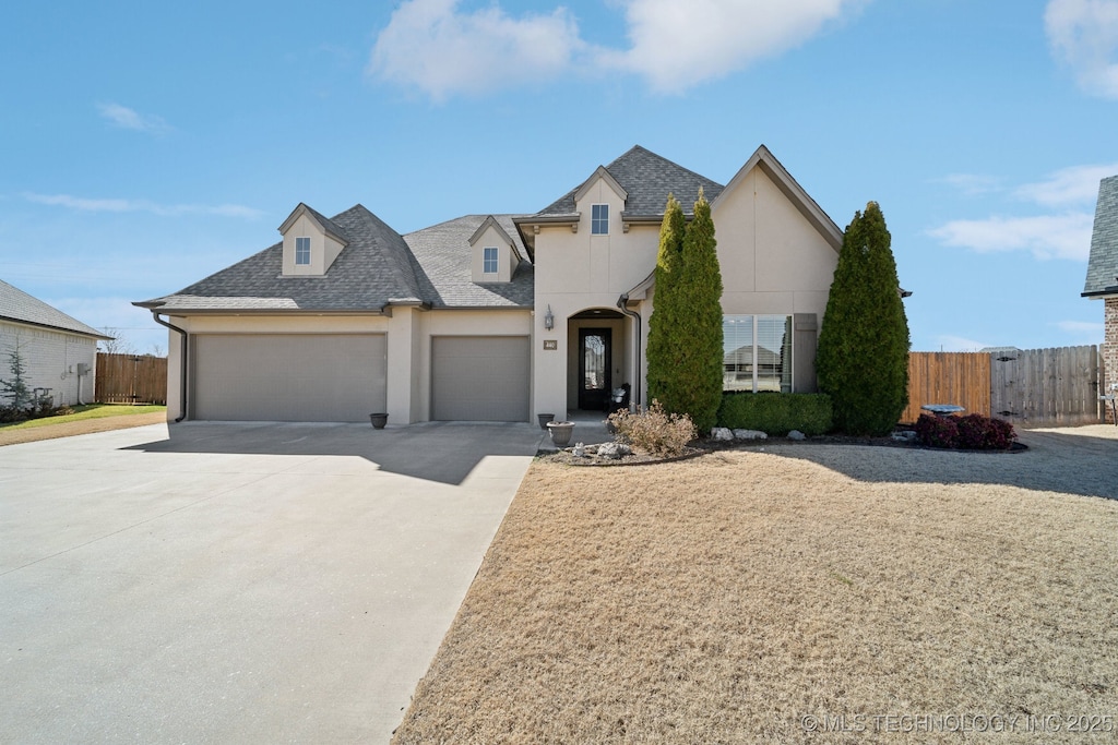 french provincial home featuring a garage